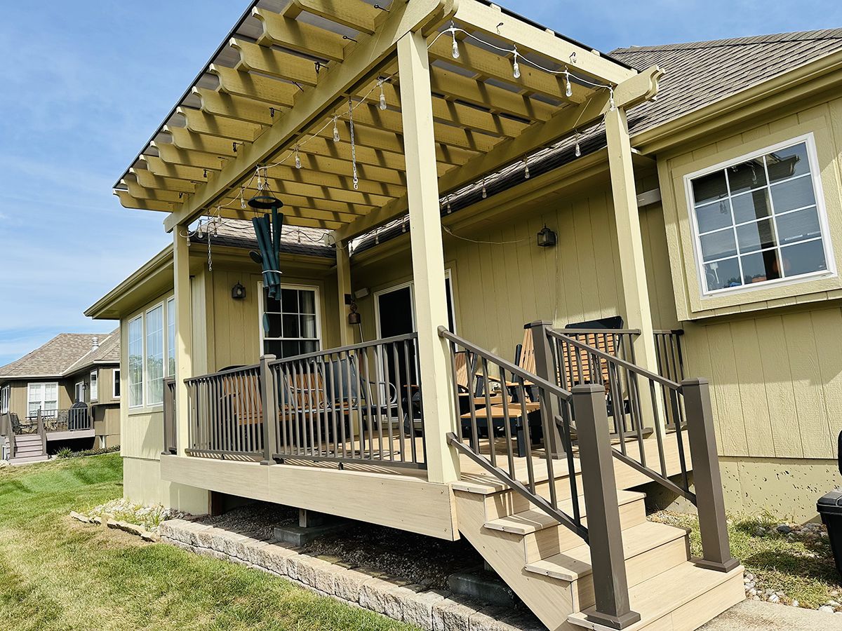 Luxury backyard pergola with seating area and pool, designed by KC Outdoor Spaces in Kansas City